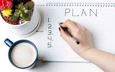 woman's hand making list of plans
